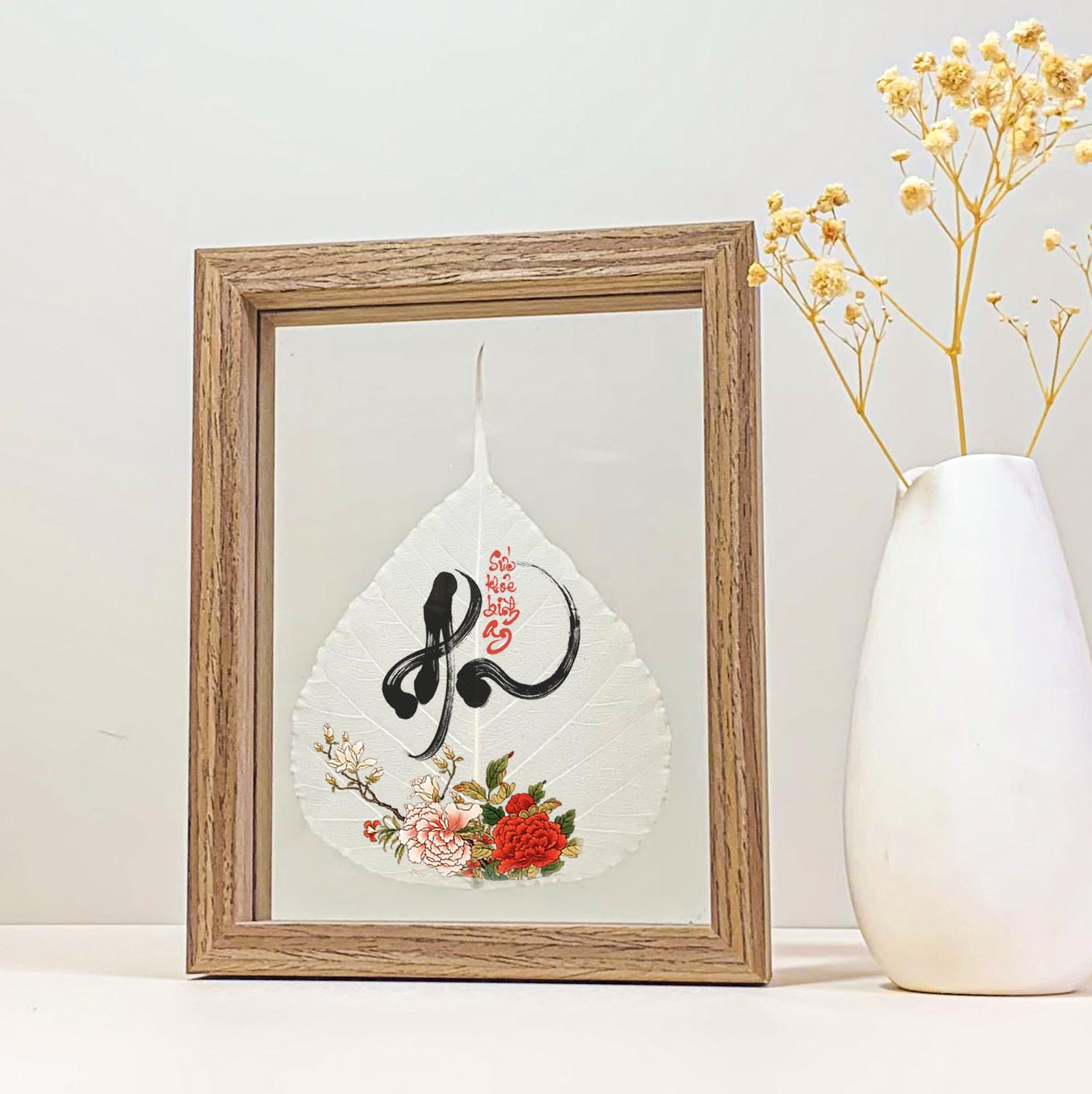 Vietnamese calligraphy An – Health & Peace (Peony) printed on a Bodhi leaf in a desk frame