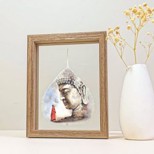 Buddha portrait printed on a real Bodhi leaf in a desk frame