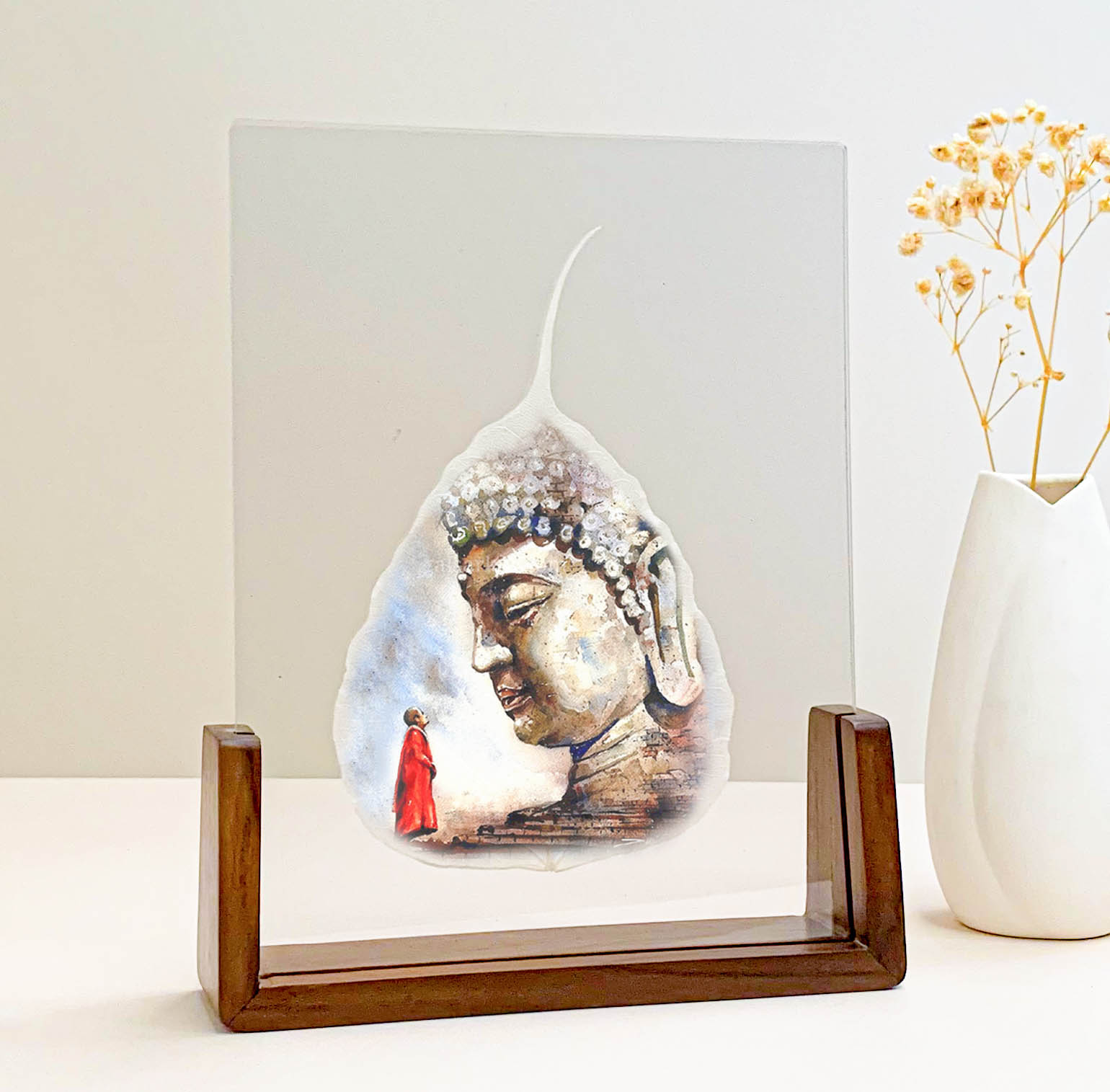 Buddha portrait printed on a real Bodhi leaf in a desk frame