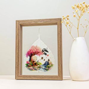 Little monk meditating printed on a Bodhi leaf in a desk frame